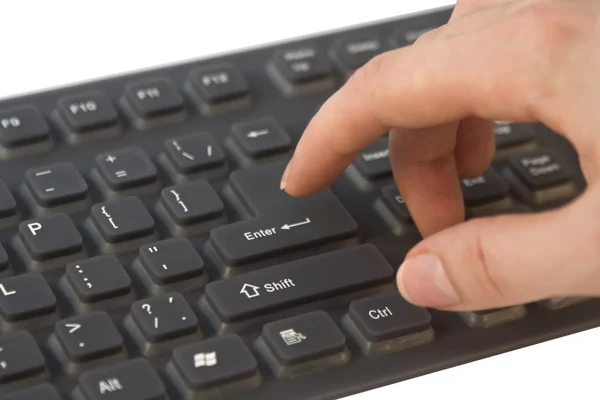 Hand above computer keyboard