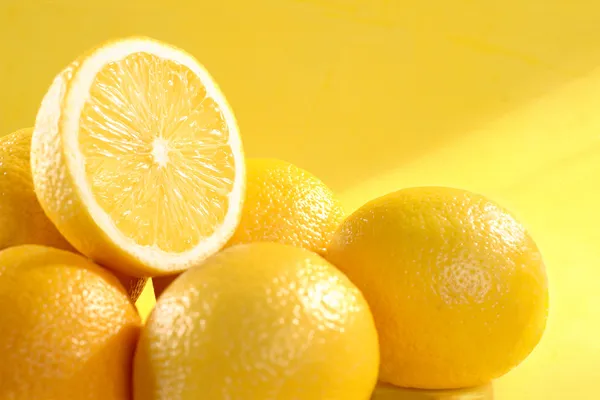 Group of lemon on yellow background