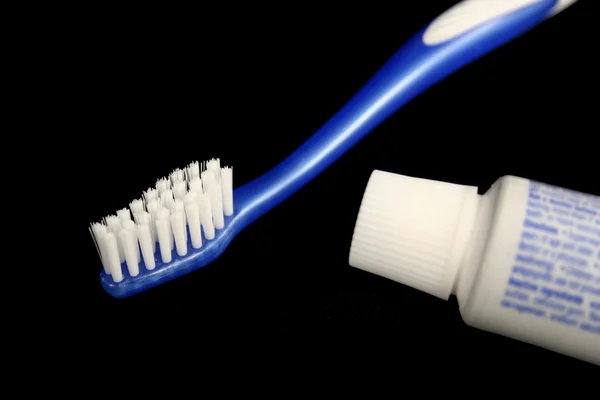 toothbrush and toothpaste. Blue toothbrush and toothpaste