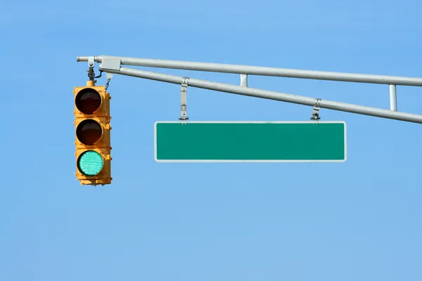 Green traffic signal light with sign