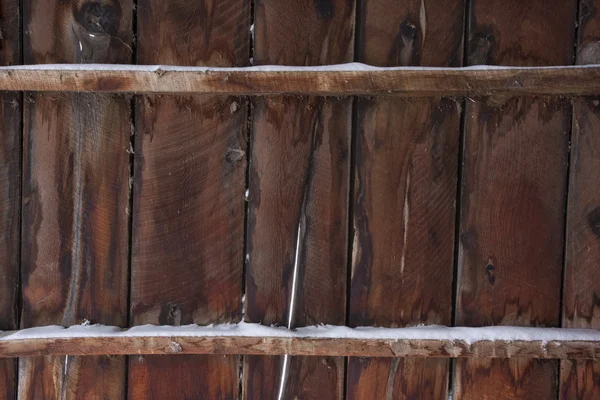 Weathered wood of old barn in winter