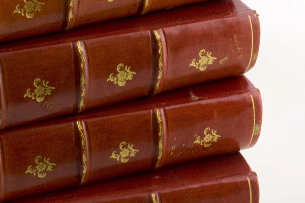 Stack of old books in red leather