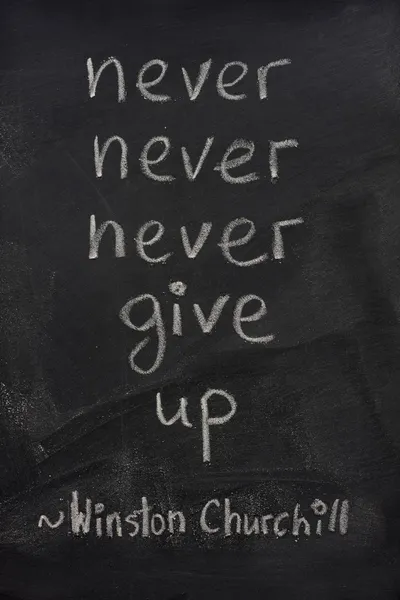 Never give up phrase on blackboard