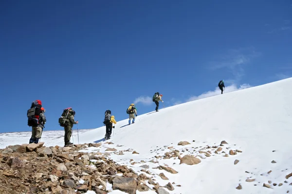 Alpinists at the climbing in Caucasus mountains, snow slope