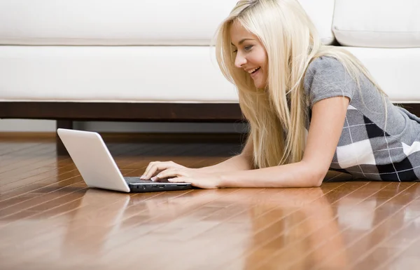 Woman Reclining on Floor With Laptop
