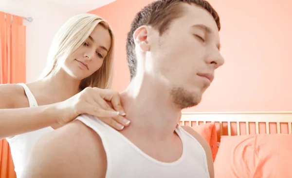 Woman Massaging Man\'s Shoulders