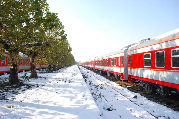 Red train on platform in winter