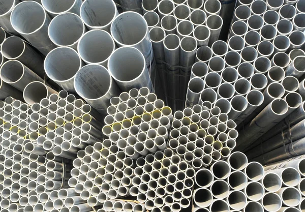 The round steel tubes of various size and caliber pile background.