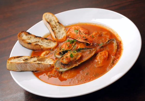 Tomato soup with seafood and toasts