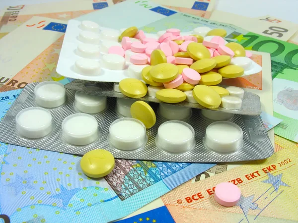 White and colored drug pills in blisters — Stock Photo #2402083