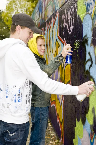 Two boys spray painting