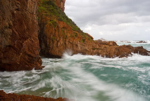 Waves crashing into cliffs