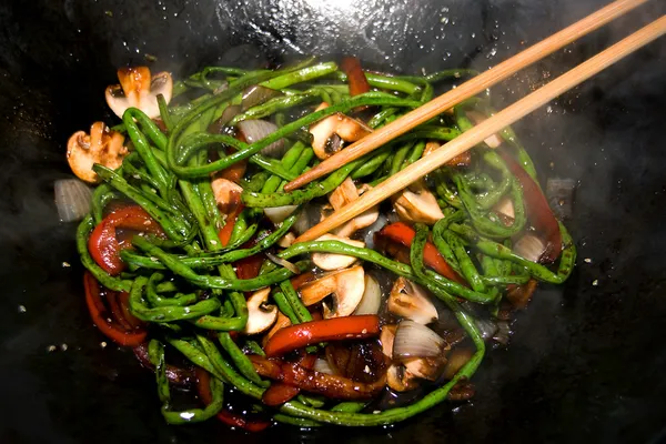 Preparing dinner in wok pan