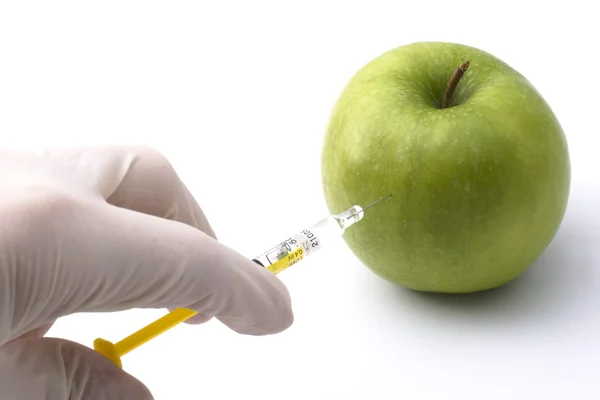 Green apple injected with chemicals