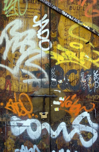 Old wooden door covered in graffiti