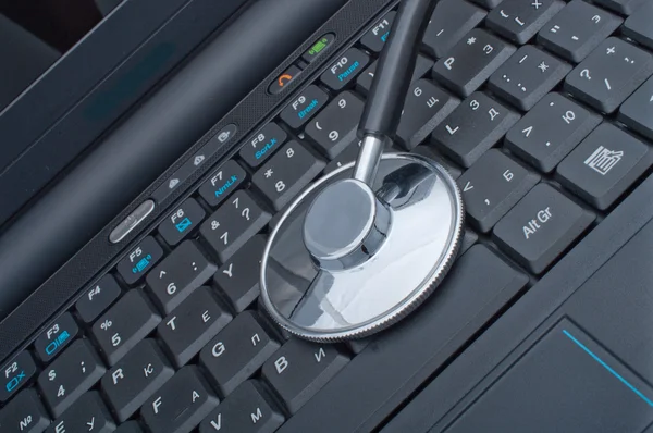 Stethoscope laying on computer