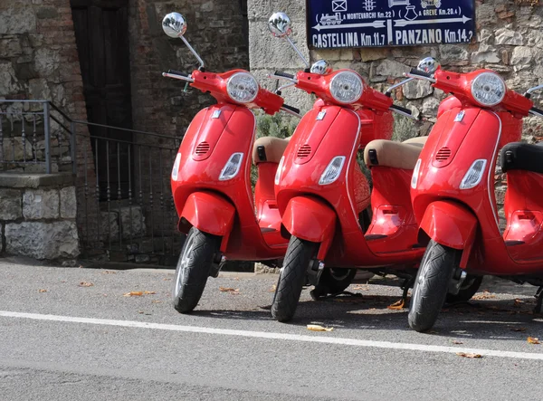 Three red scooters in Tuscany
