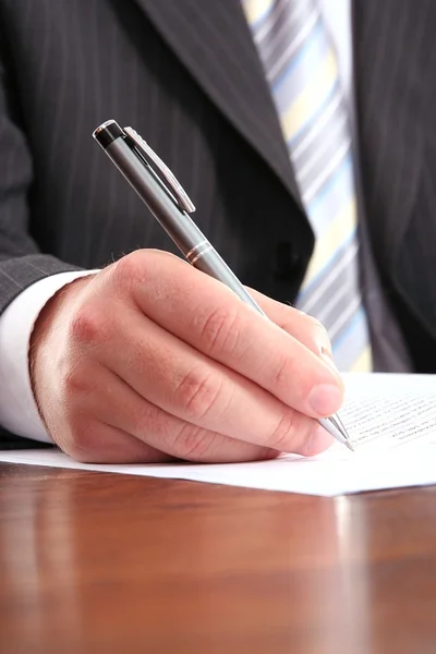 Businessman writing on a form