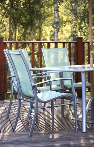 Chairs on decking in summer light