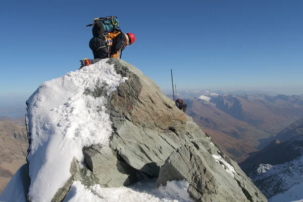 Climber climbing mountain ridge