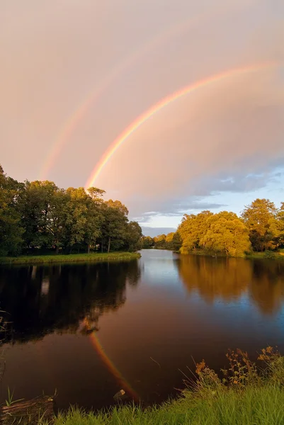 Rainbow over autumn pond