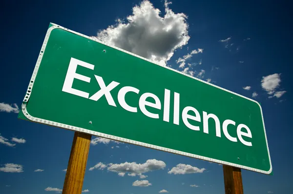 Excellence Road Sign Over Sky and Clouds