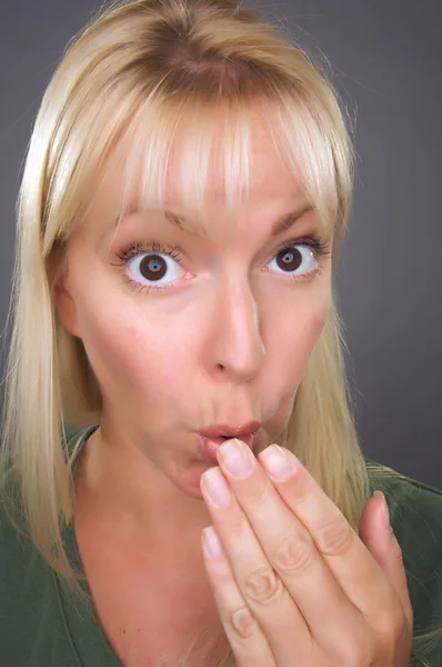 Shocked Blond Woman with Hand in Front
