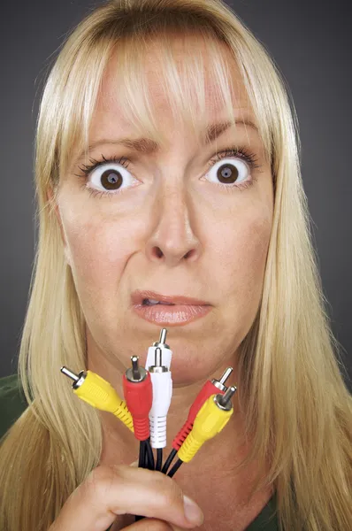 Confused Woman Holding Electronic Cables