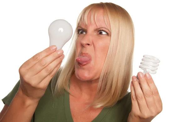 Angry Faced Girl Compares Light Bulbs