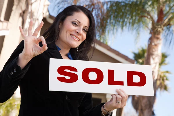 House and Woman Holding Sold Sign