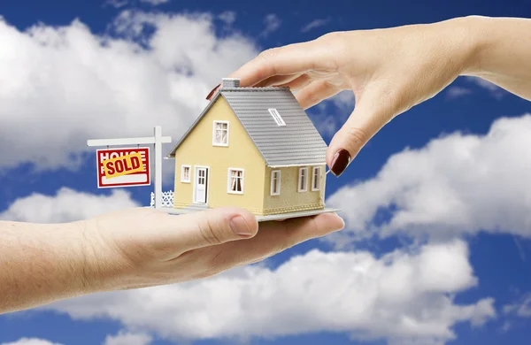 Reaching For Home with Real Estate Sign