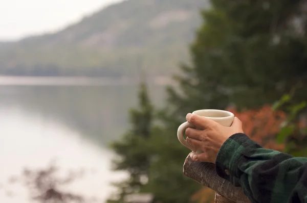Woman Enjoys Morning Cup Coffee at Lake