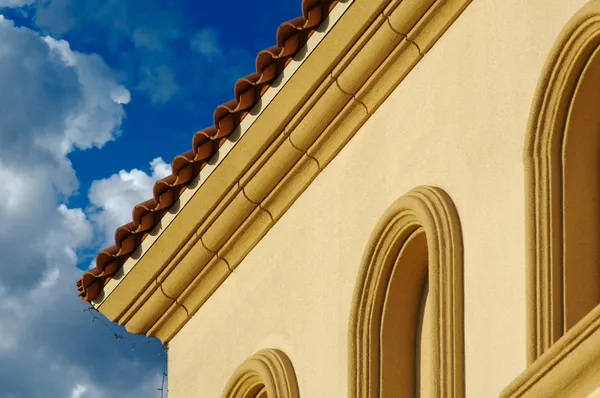 Stucco Wall Arched Windows and Clouds