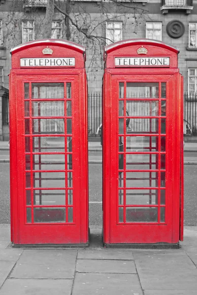Two typical London red phone cabins