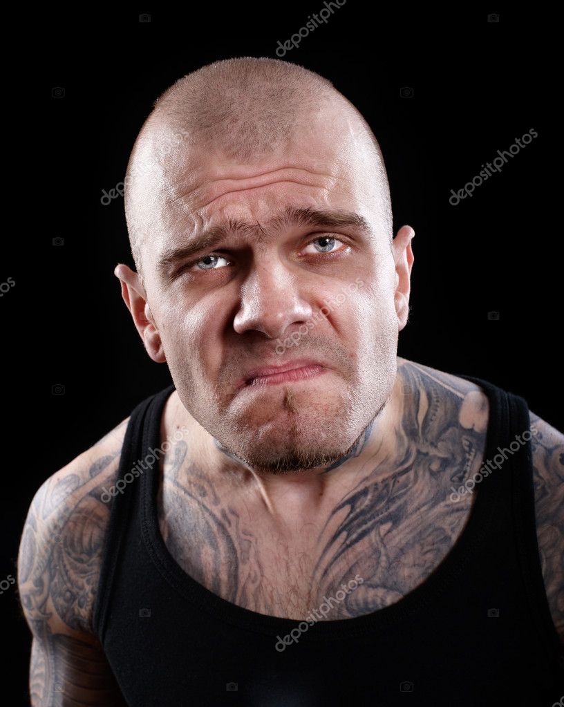 Tattooed man with displeased