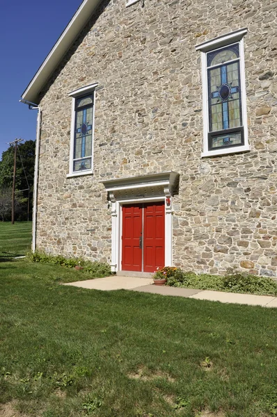 Stone church with red doors