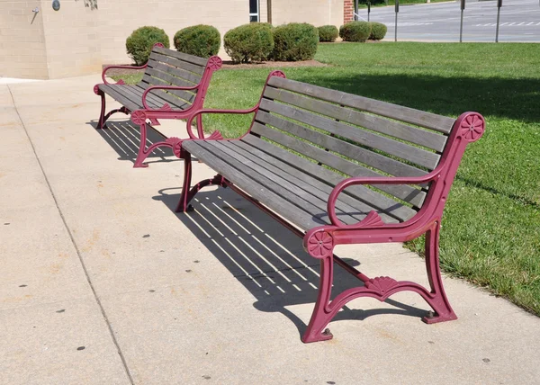 Two empty outdoor benches