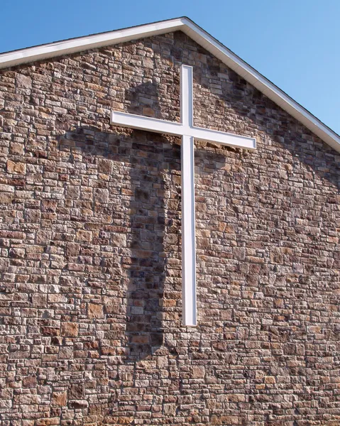 White cross on stone church building