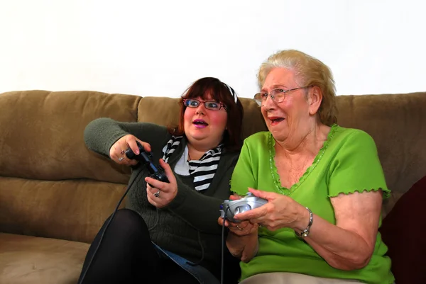 Granddaughter And Grandmother Playing Vi