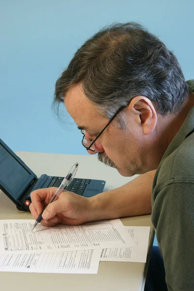 Man Doing 1040 Federal Income Tax Form