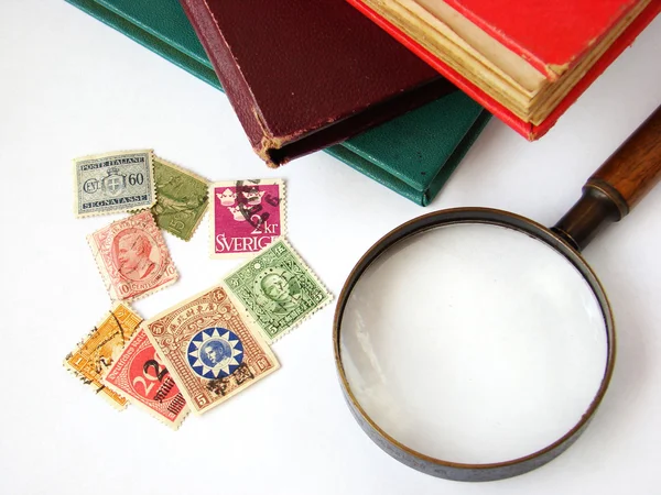 Postage stamps and magnifying glass