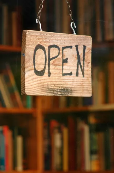 An open book shop sign