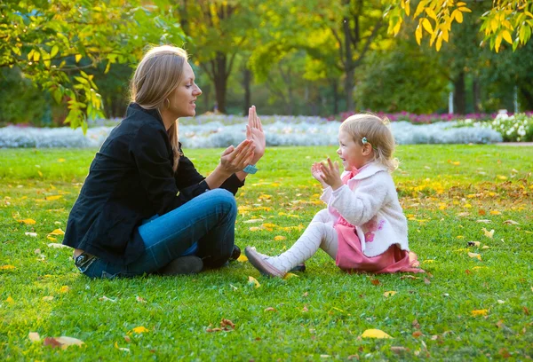 Mother and daughter play in the park
