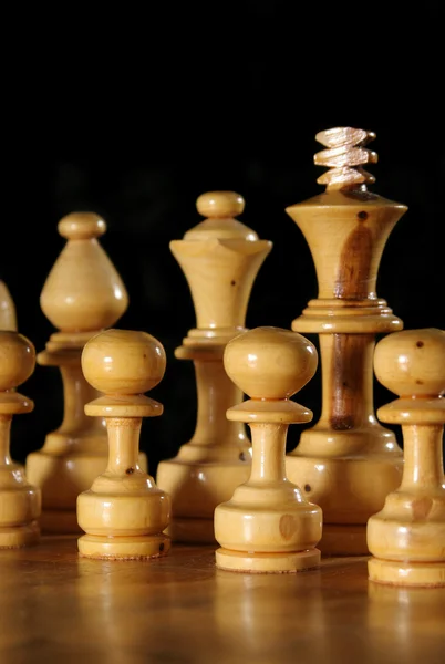 Close up of Wooden Chess Pieces on Black