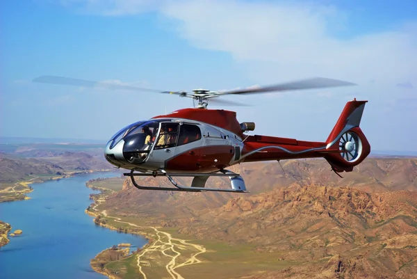 Helicopter on river in desert