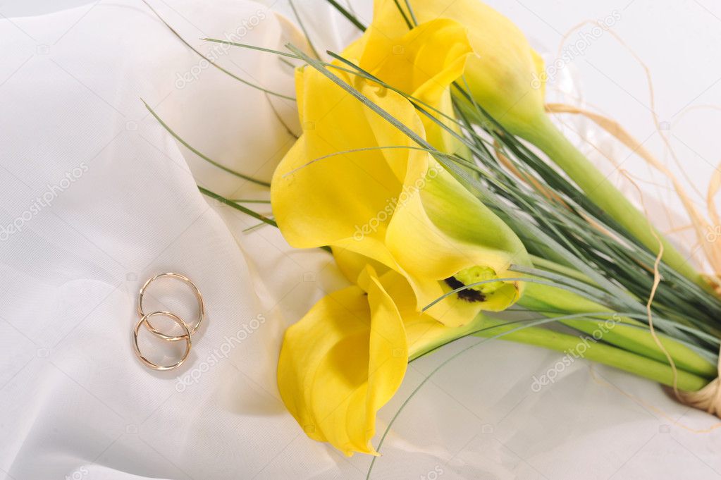 Yellow flowers and wedding rings
