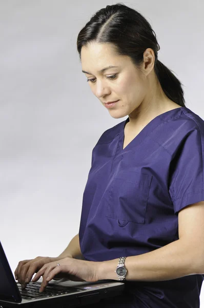 Asian medical person with computer.