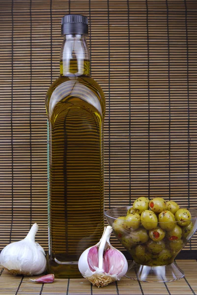 Olive oil bottle and olives