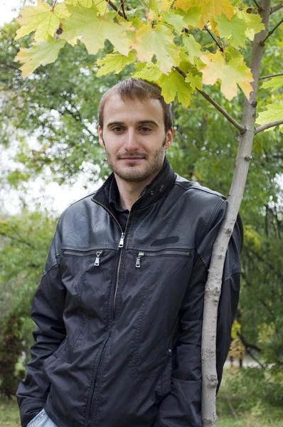 stock image Young man standing near the autumn tree