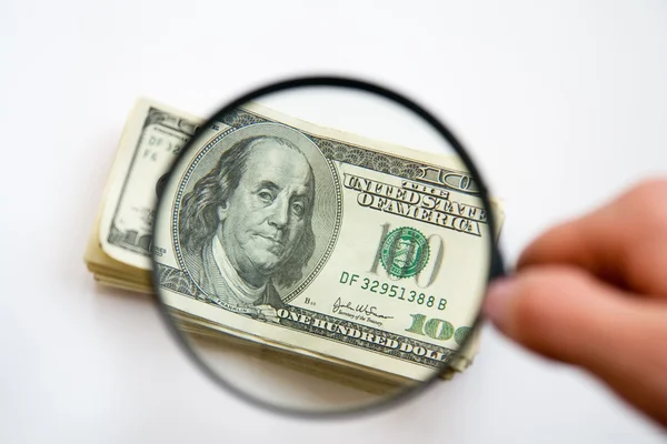 Hand Holds Magnifying Glass Hundred Dollar Bills — Stockfoto